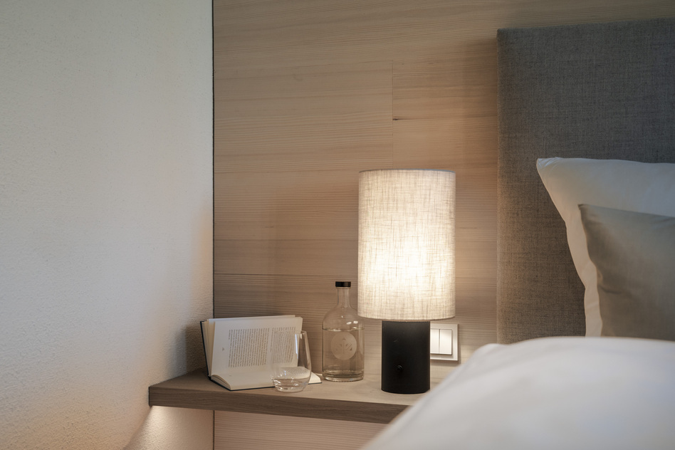 A bedside table and bed in a room at Seegut Zeppelin in Friedrichshafen